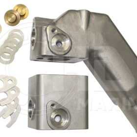 A pair of metal parts with some white plastic and brass hardware.
